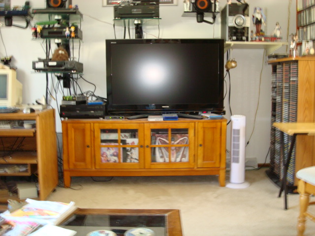 The main viewing LCD TV. There's one just like it downstairs. More LDs fill the center 2 areas of the entertainment center. DVDs from Japan are on the far right and left cabinet doors. The sub-woofer is behind the TV.