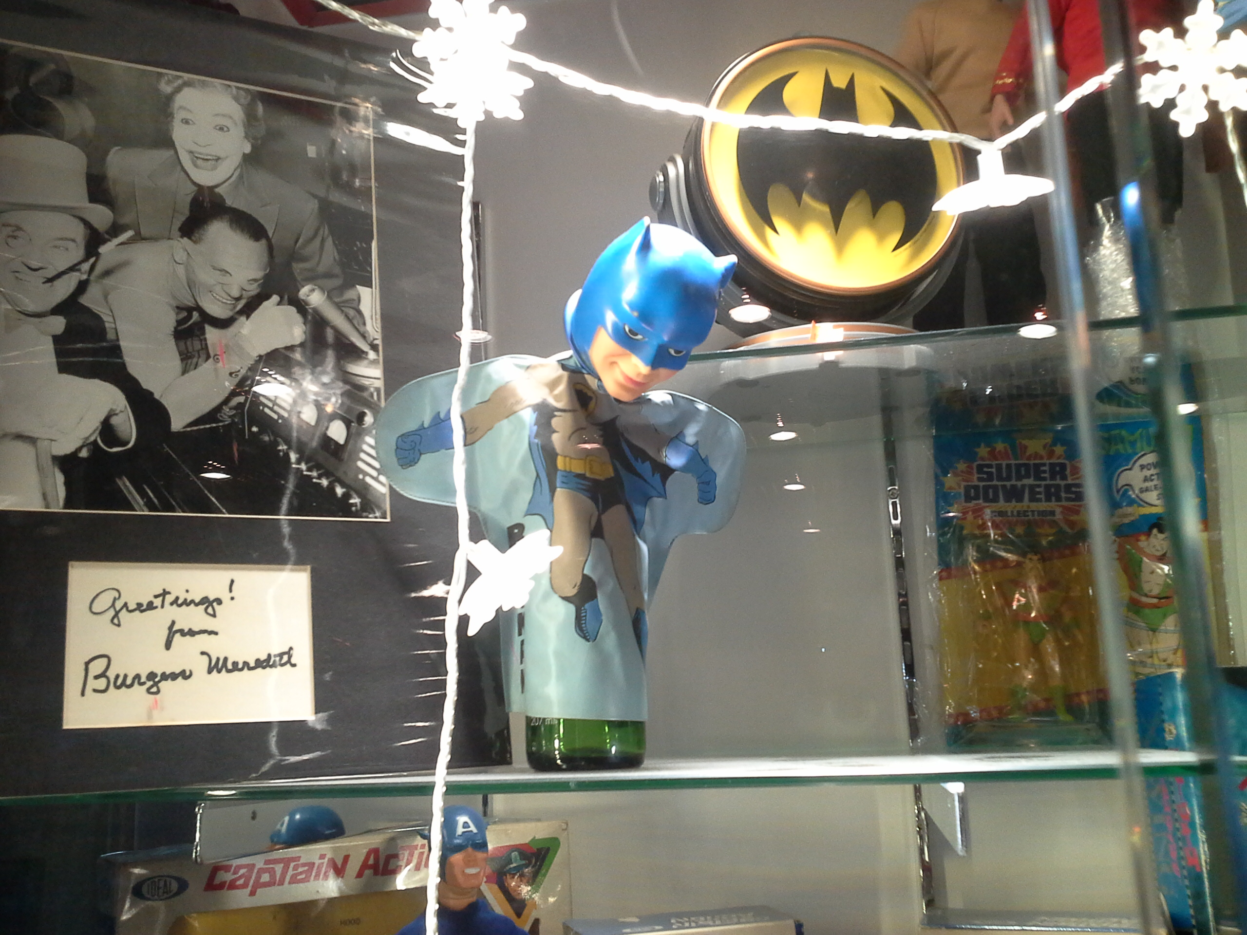 A great old Batman beer bottle cover(?) next to the autograph of Mr. Penguin himself, Burgess Meredith!